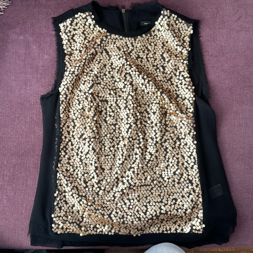No sleeves, golden sequins on the front. Back zipper. Sheer back.